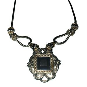 Blue stoned necklace attached to a silver toned necklace with gold accents